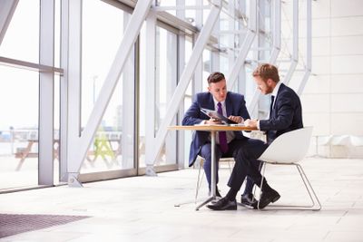 Two business colleagues at meeting in modern office...