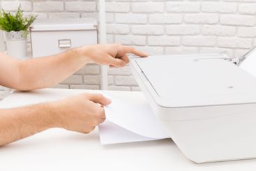 Manual paper handling at a home office setup includes...