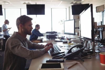 Concentrated businessman working on computer at office