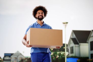 Successful African American courier delivering package