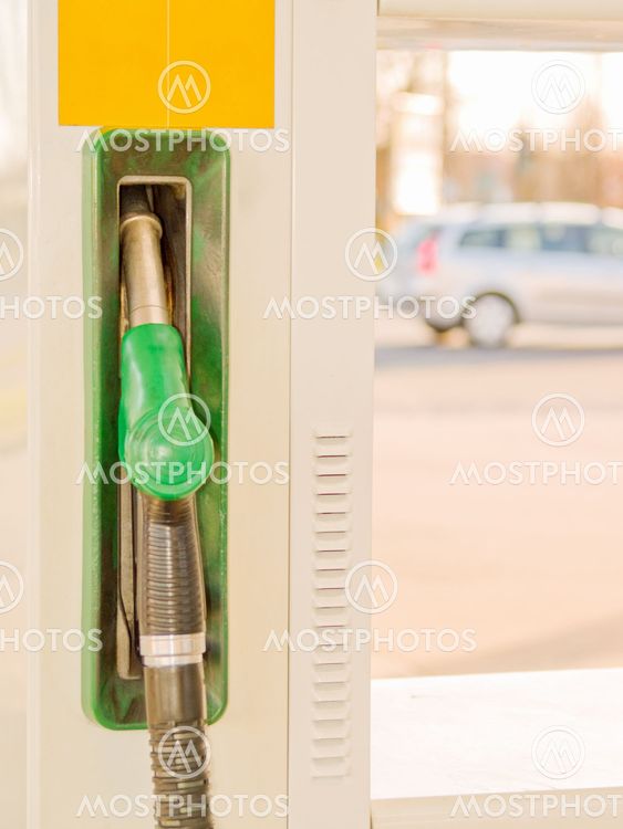 Service Station - Fuel nozzle with car in background