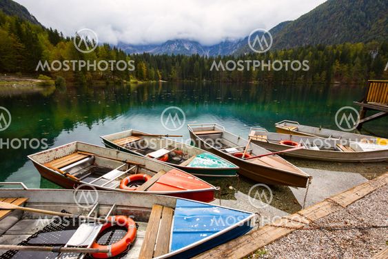 Alpine landscape and colorful boats, Lake Fusine,Italy