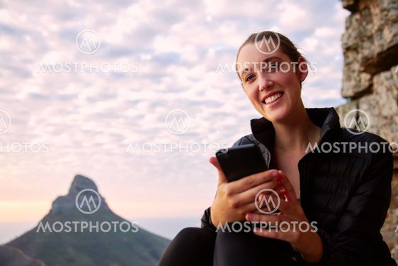 Portrait Of Young Woman Hiking Along Coastal Path...