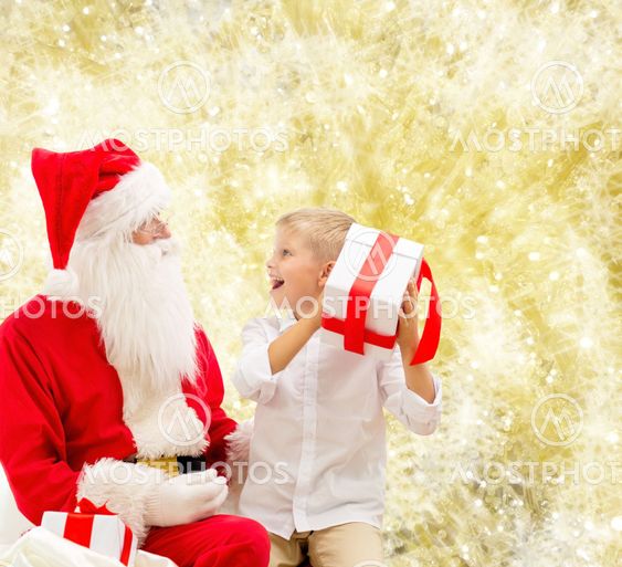 smiling little boy with santa claus and gifts