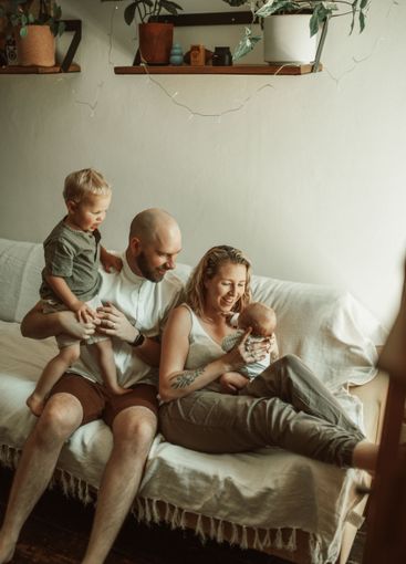 Parents, children and love with a family on the sofa in...