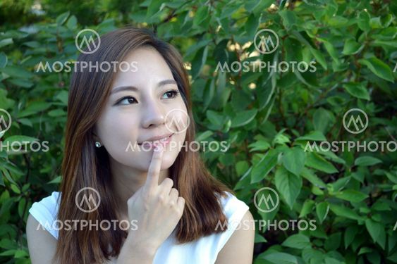 Beautiful young asian woman thinking