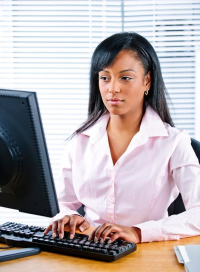 Serious black businesswoman at desk