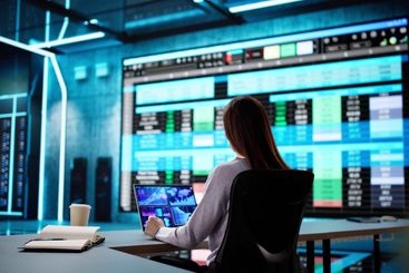 Professional Woman Analyzing Medical Data on Laptop