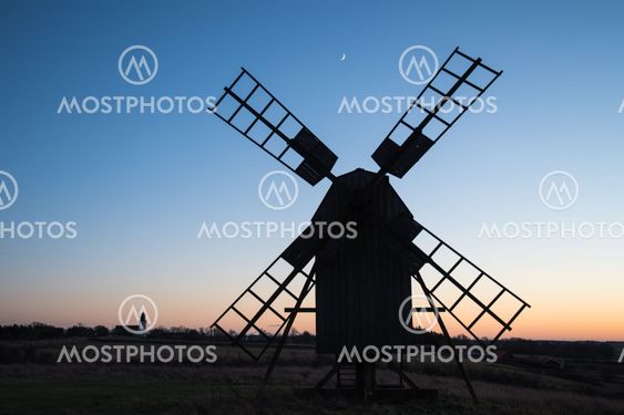 Traditional windmill and a church silhouettes