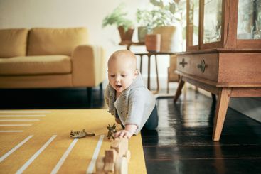 Baby, toys and child play in home, having fun and...