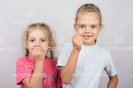 Six year old girl showing her teeth, four-year girl...