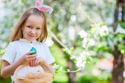 Little girl playing with Easter eggs