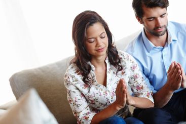 Christian, worship and couple praying in home for calm...