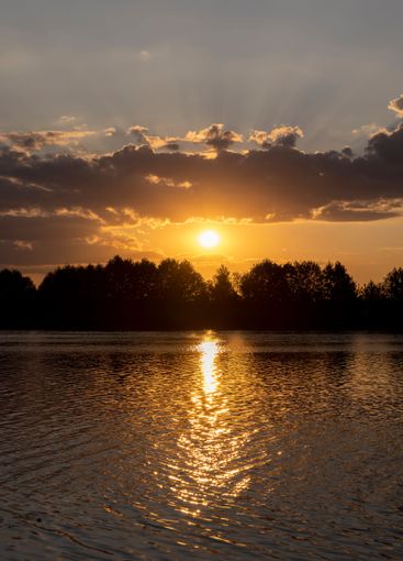 the lake with orange water in the summer at sunset