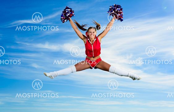 Young cheerleader in red costume jumping