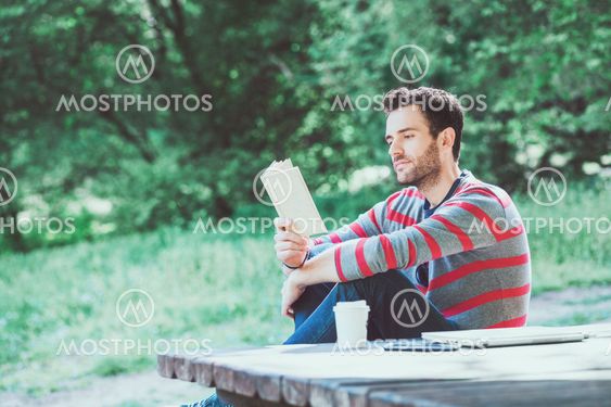 Young man reading a book