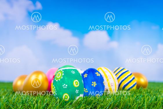 Easter Eggs on Fresh Green Grass over blue sky