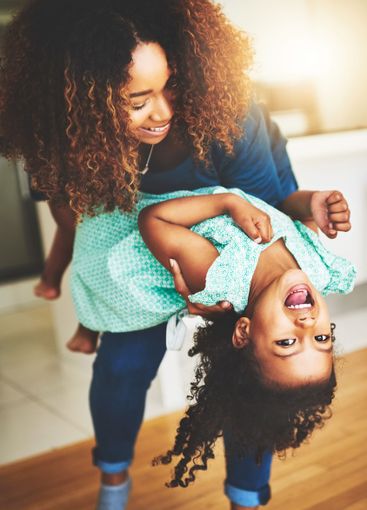Fun, mom and child in home, playing and laughing in...