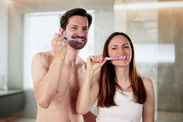 Couple enjoys morning routine together in bright bathroom