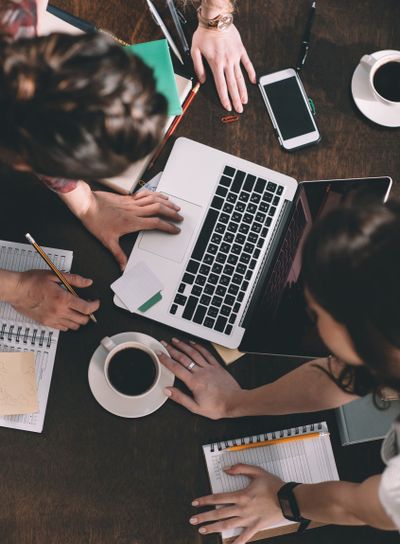 top view of women studying with books and laptop