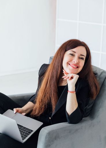 woman brunette sitting on chair online laptop