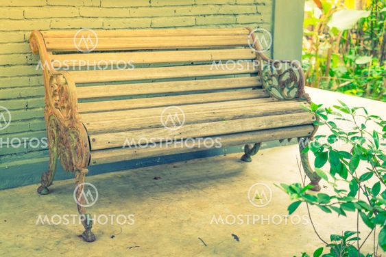 Wood Bench against brick wall . ( Filtered image...