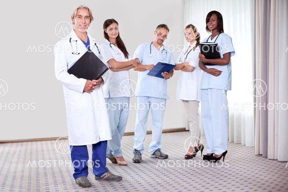 Team of professionals lead by mature doctor