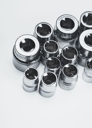 Selection of polished metallic socket wrenches arranged...
