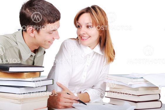 Male and female student learning and helping each other...
