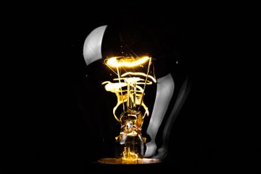 Close-up of electrical bulb on black background