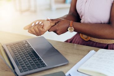 Hands, laptop and wrist pain with a business person in...