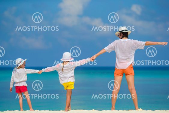 Little girls and mother on tropical white beach