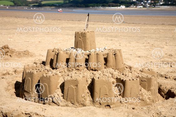 A big sandcastle on the beach.