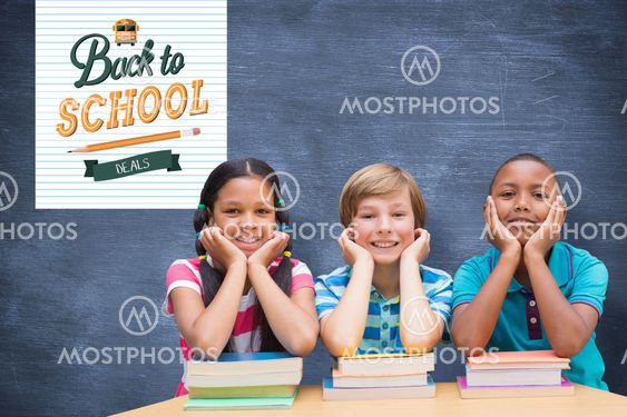 Composite image of cute pupils looking at camera in library