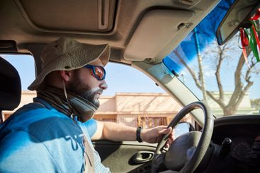 Side portrait of a man traveling by car, concentrating...