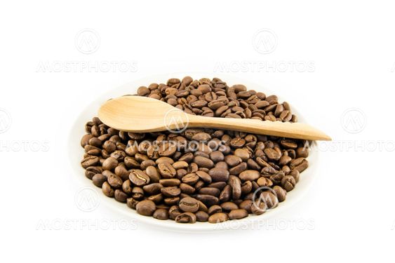 Cup full of coffee beans isolated