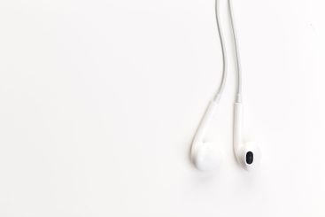Pair of earphones close up on grey background