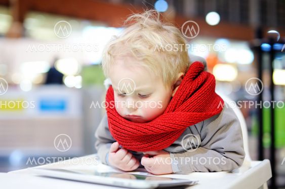 Toddler boy playing with a digital tablet