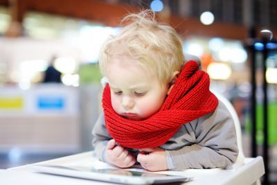 Toddler boy playing with a digital tablet 