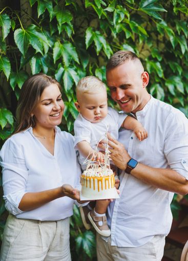Mom and dad in nature with their one-year-old son...