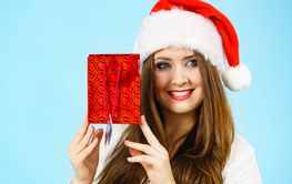 Happy Christmas woman holds red gift bag