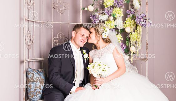 Wedding couple indoors is hugging each other. Beauty...