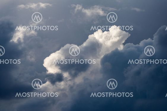A close up detail shot of stormy and moody sunlit clouds