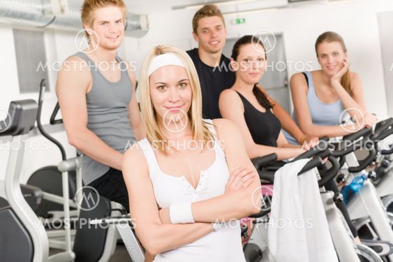 Fitness young group people at gym bicycle