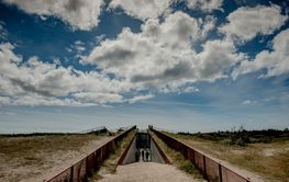 Clouds above beach walkway
