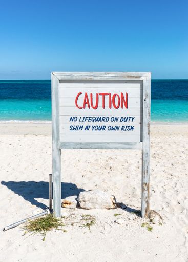 Poster on the seashore - Caution: No lifeguard on duty....