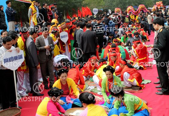 People in traditional costume exam to make square...