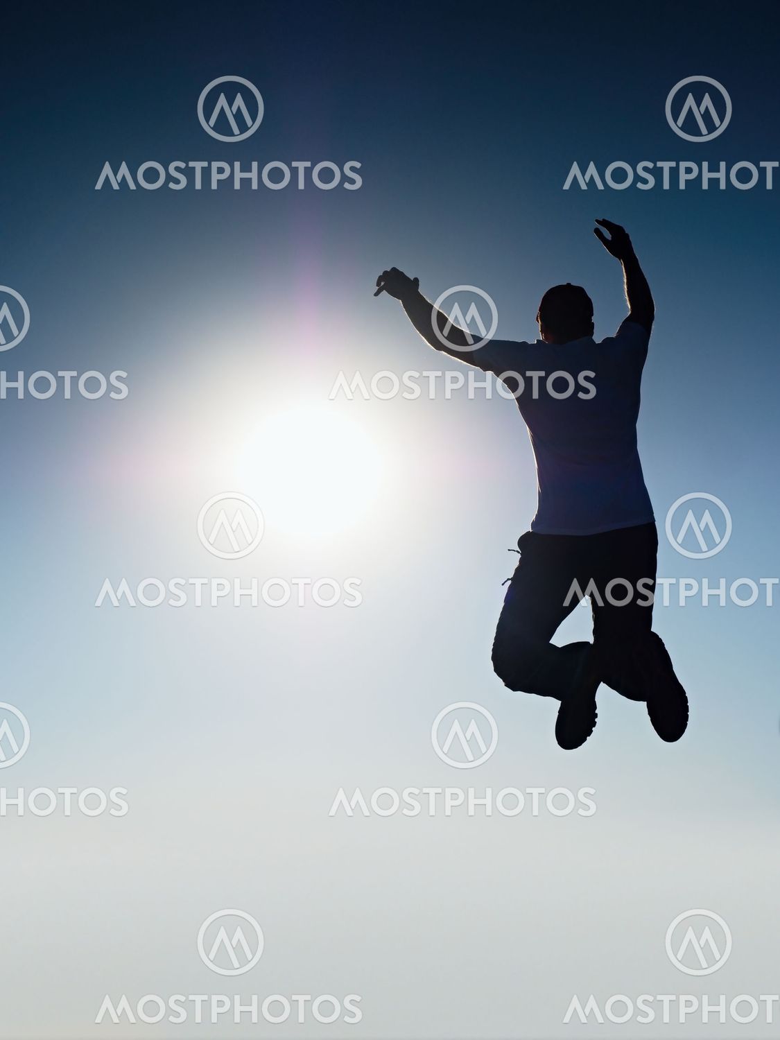 "Man fly in air. Blue Toned..." av rdonar Mostphotos