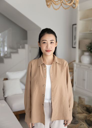 Positive beautiful young adult Asian girl posing at home