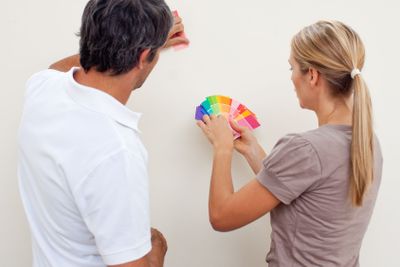Couple choosing a color to paint a room 